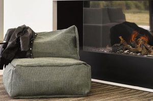 Roolf chair in front of a black fire place
