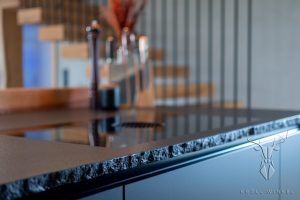 Black countertop kitchen with rough edge