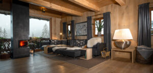 Oak livingroom with cozy loden couch and steel fireplace