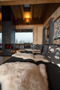 anthracite-coloured sofa, complemented by natural sheepskins