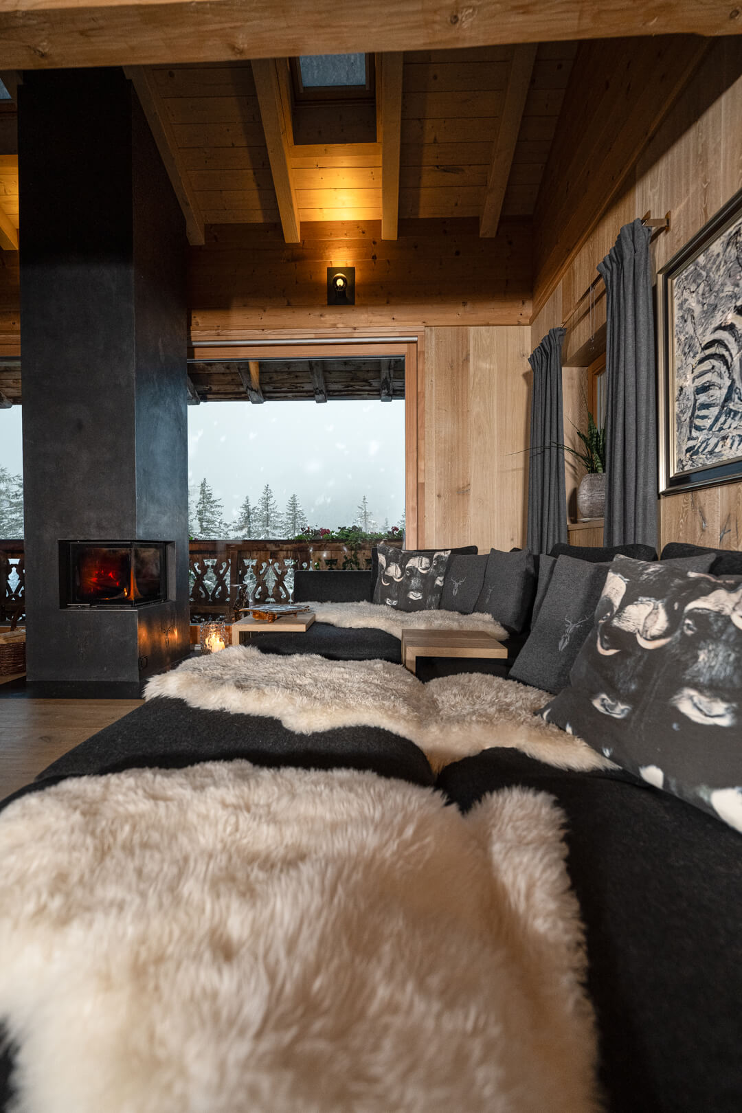 anthracite-coloured sofa, complemented by natural sheepskins