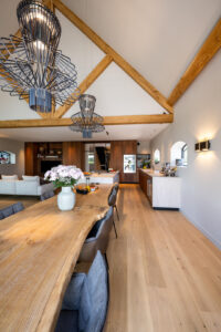 Oak table with matching floorboard and light marble kitchen