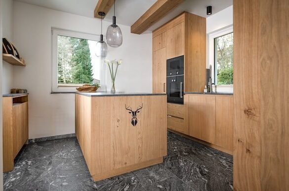 Light wash oak kitchen. Anthrazit natural stone countertop.