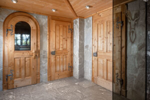 Alpine-style interior with traditional wooden chalet doors.