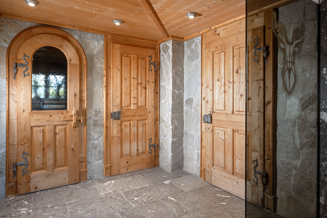 Alpine-style interior with traditional wooden chalet doors.