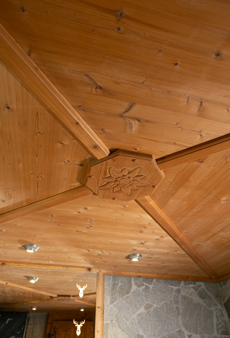Chalet interior with Edelweiss-themed oak ceiling.