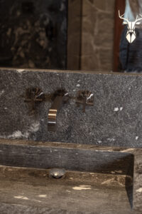 Luxury Axor brushed black faucet in stone bathroom.