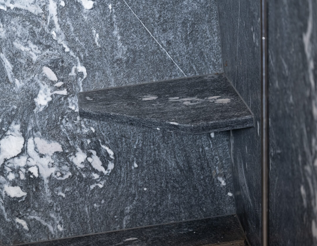 Shower with built-in stone bench in chalet bathroom.
