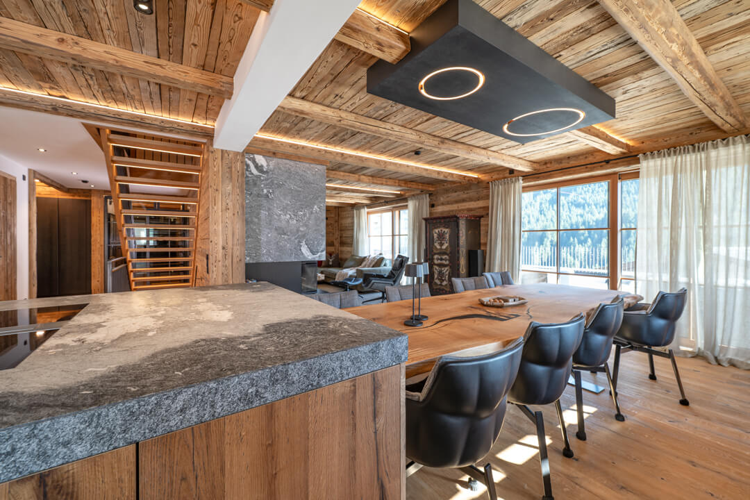 lpine chalet kitchen with solid oak table, kitchen island, natural-edge design, and elegant black steel accents.