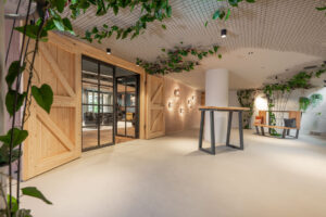 Hotel gallery with loft-style doors and oak barn doors leading to the fireplace room.