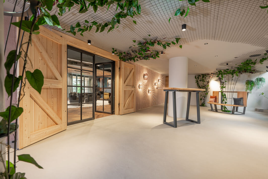 Hotel gallery with loft-style doors and oak barn doors leading to the fireplace room.