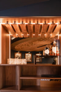 Handcrafted walnut whiskey cabinet with ambient lightning.