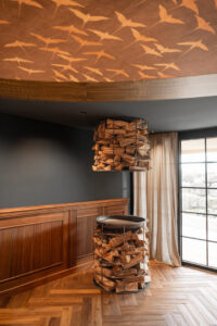 Champagne cooler with steel body in a wooden tower display.