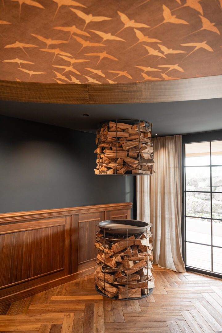 Champagne cooler with steel body in a wooden tower display.