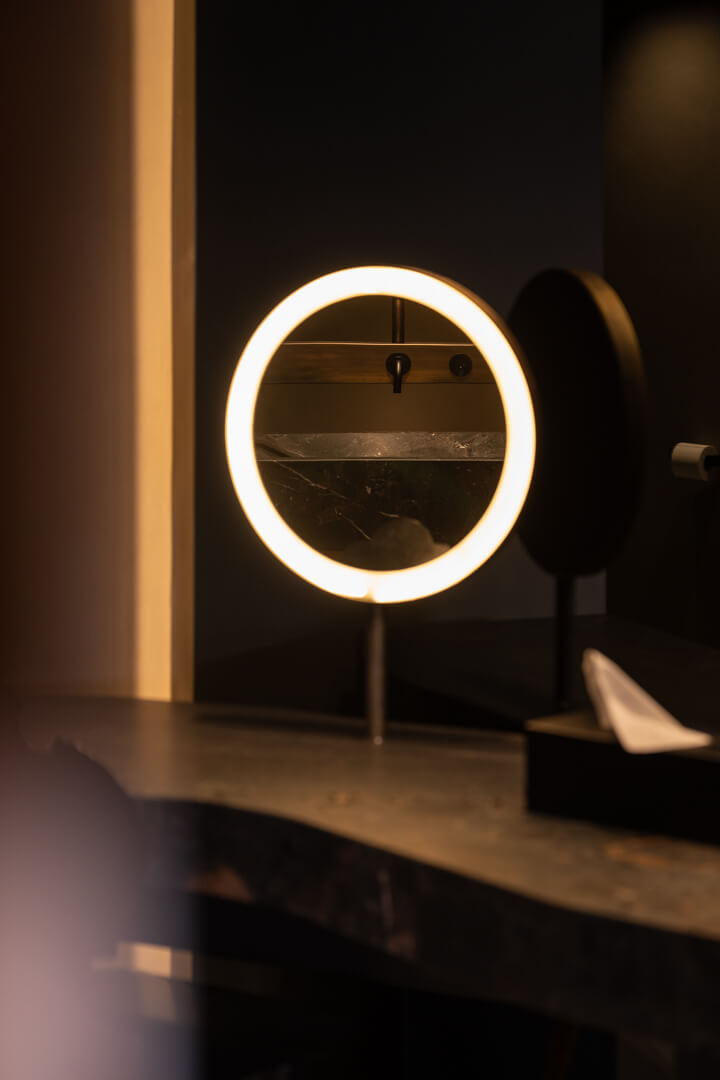 Luxury makeup table with lighted mirror in a stylish interior.