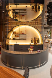 Imposing, illuminated hotel bar featuring delicate steel mesh and refined interior design.