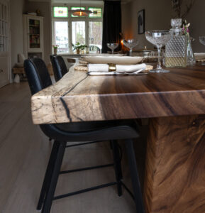 Acacia table made from a single solid top and matching solid end panel.