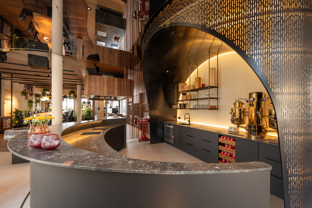 Hotel bar with natural stone countertop and impressive backlit delicate steel structure.