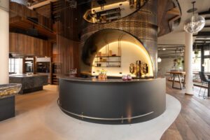 Imposing, illuminated hotel bar featuring delicate steel mesh and refined interior design.