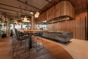 grand walnut kitchen with grey natural stone island. 7,5 long Oak table.