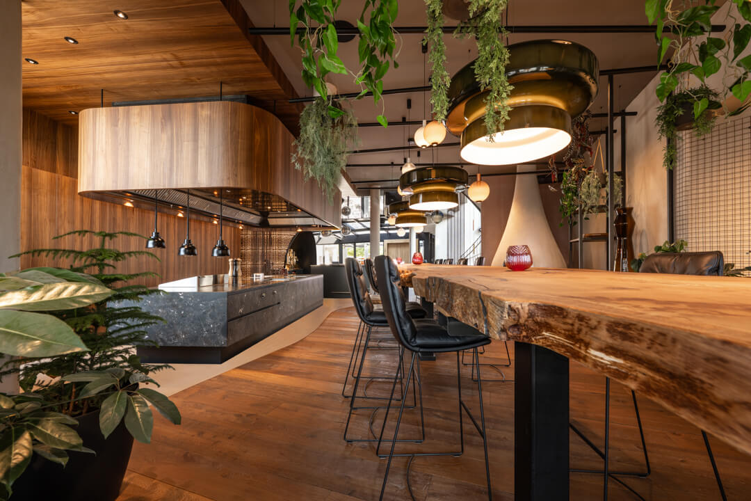 Luxury walnut kitchen with grey natural stone island. 7,5 long Oak table.