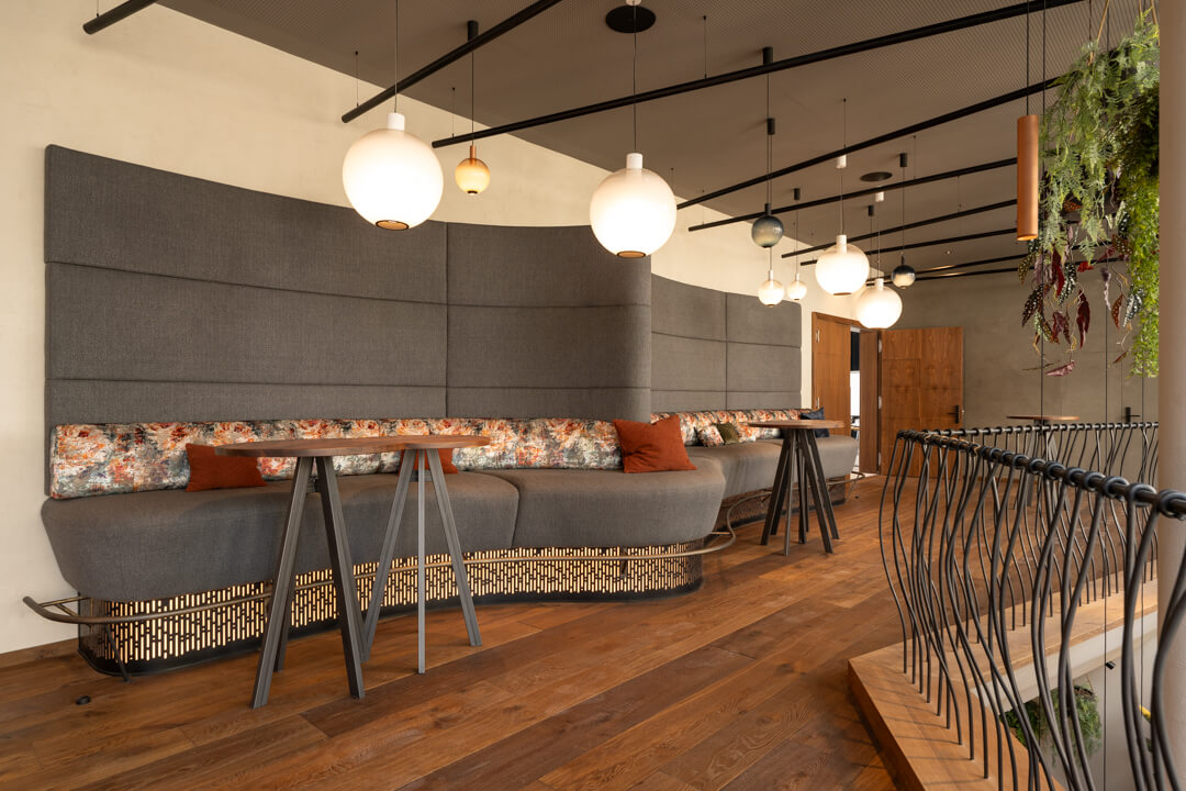 Dynamically designed foyer with a long bench and steel railing.