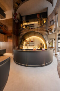 Imposing, illuminated hotel bar with delicate steel mesh.