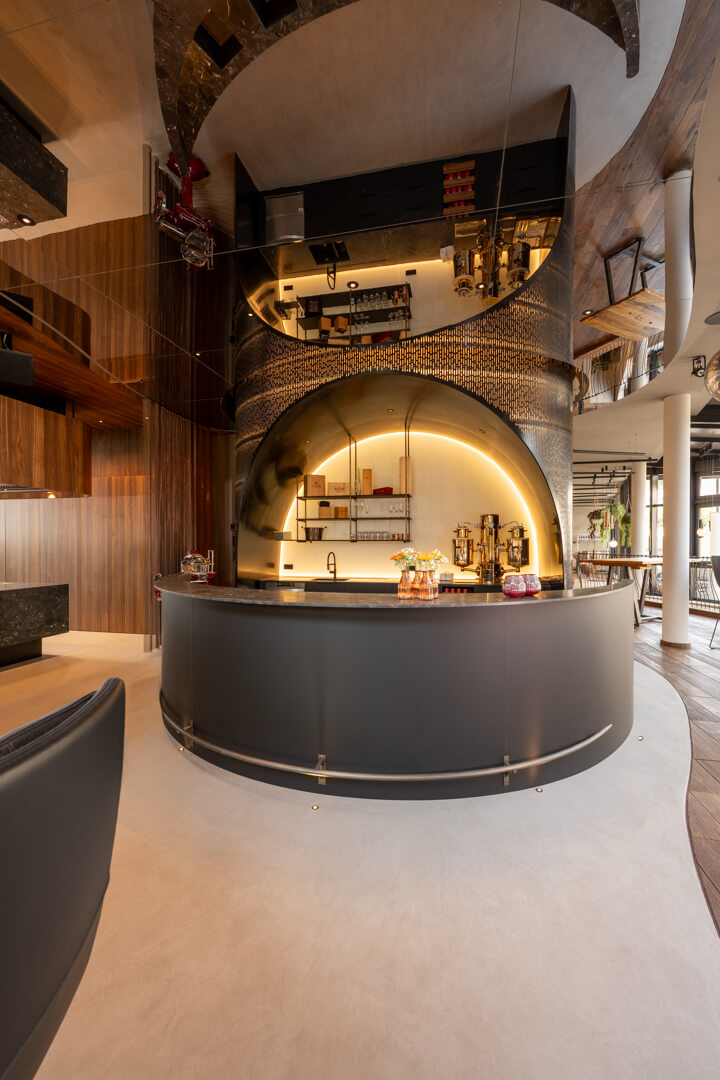Imposing, illuminated hotel bar with delicate steel mesh.