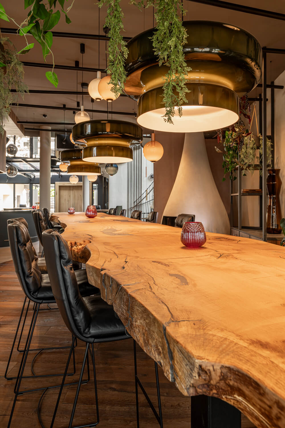 Long oak table natural dynamic edge. Black leather bar chairs