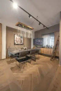 Herringbone oak flooring and dark smoked dinner table