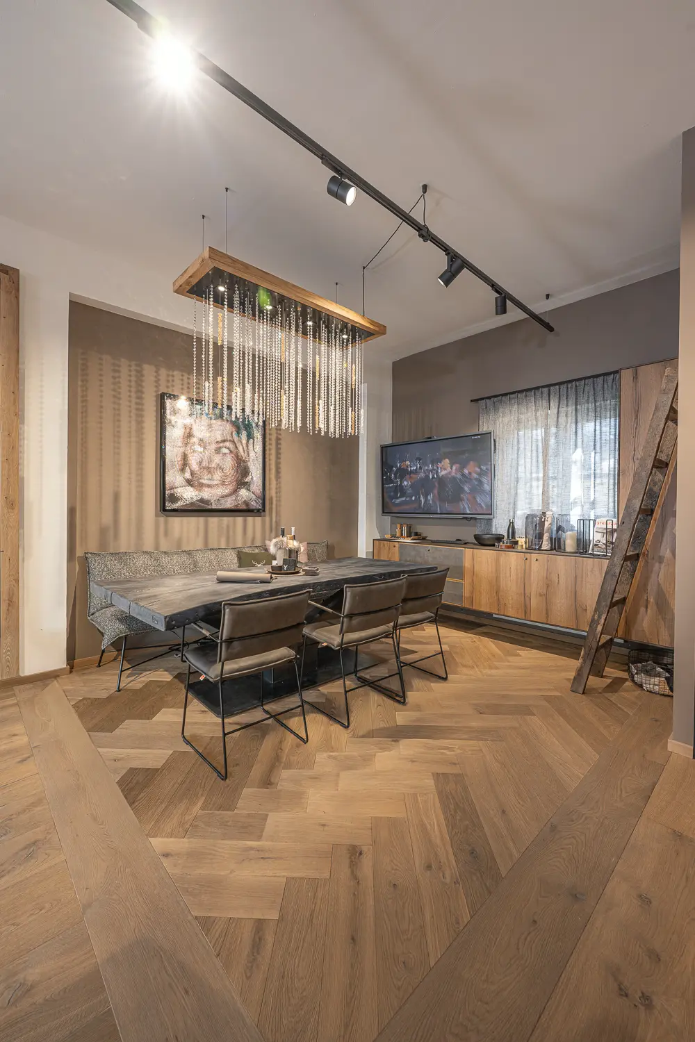 Herringbone oak flooring and dark smoked dinner table
