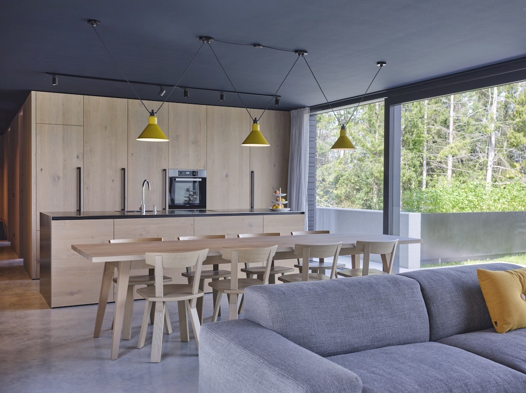 Haus und Hof clean oak kitchen with island and oak table.