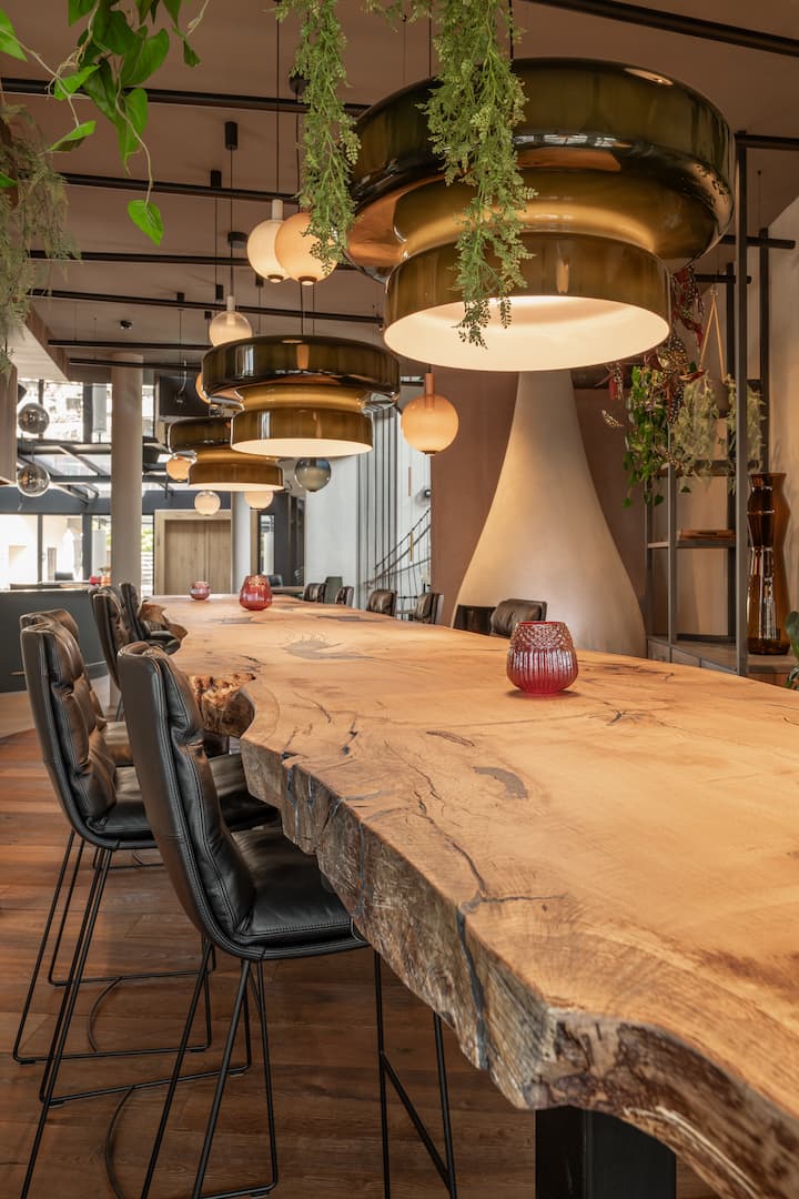 Long oak table natural dynamic edge. Black leather bar chairs