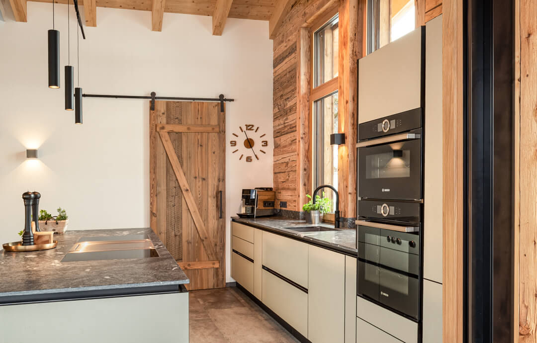 Chalet kitchen with island lightgreen with wooden details