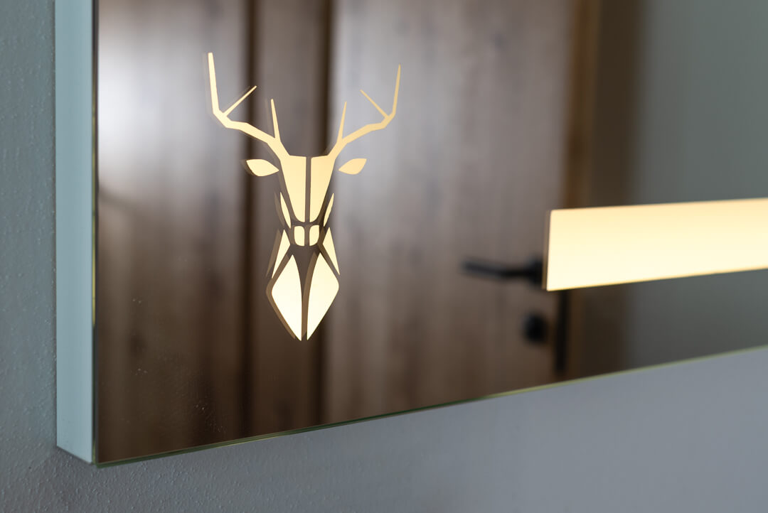 Illuminated mirror with stag detail